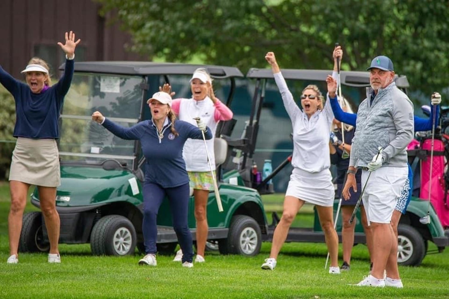 Stacy and others celebrating an amazing shot, hit by Darren Clarke at the 2021 Sanford International Senior PGA Tournament